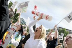 Amanda Tompkins and others shout during a rally to protest recent court rulings and proposed legislative changes that would make it harder for some licensed patients to get the drug, Wednesday, Sept. 7, 2011 at the state Capitol, in Lansing, Mich. (The State Journal, Greg DeRuiter / AP)