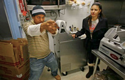 Sirilo Ortiz, former owner of Lycomings Grocery, re-enacts his ordeal with cops just five days after buying the Hunting Park shop. He says plainclothes officers entered his store aiming their guns at him. Maria Espinal also was in the store.